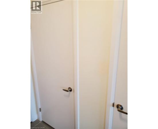 Two white doors with silver handles.