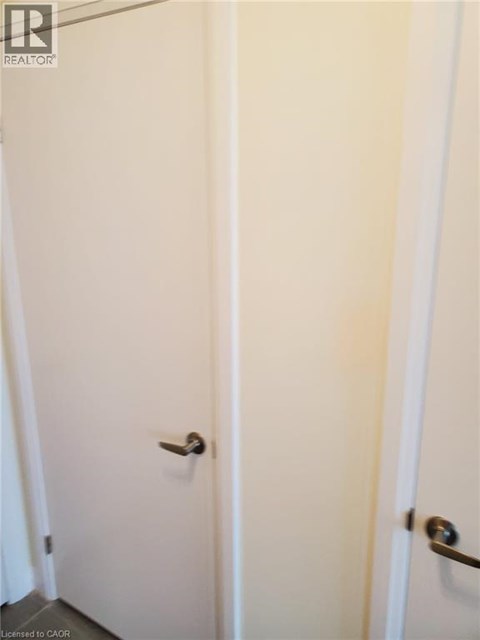 Two white doors with silver handles.