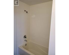 A white bathroom with a tub and shower.