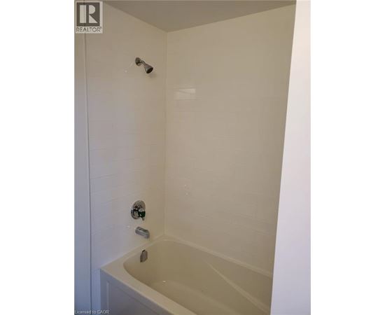 A white bathroom with a tub and shower.