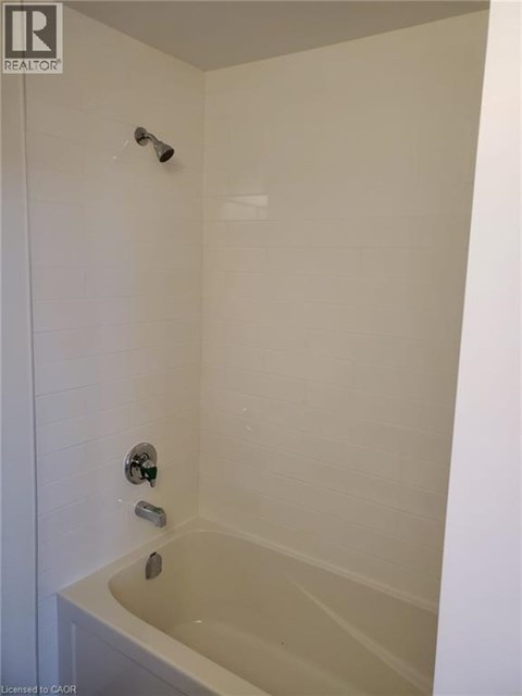 A white bathroom with a tub and shower.