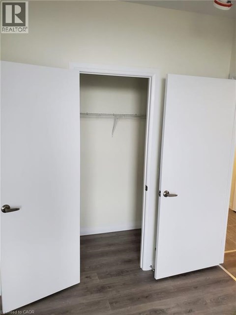 A white door is open to a room with a white wall.