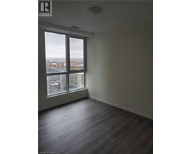 A room with a large window overlooking a cityscape.