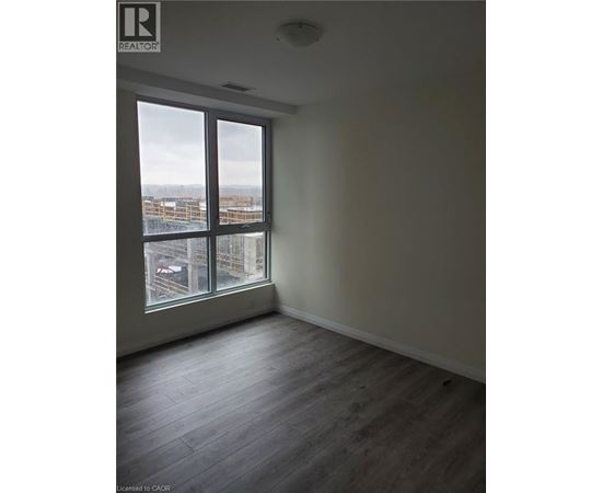 A room with a large window overlooking a cityscape.