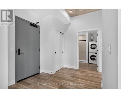 A modern kitchen with a washer and dryer in the laundry room.