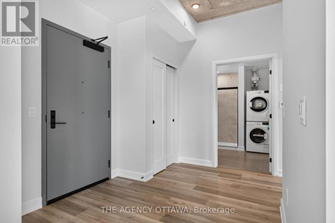 A modern kitchen with a washer and dryer in the laundry room.