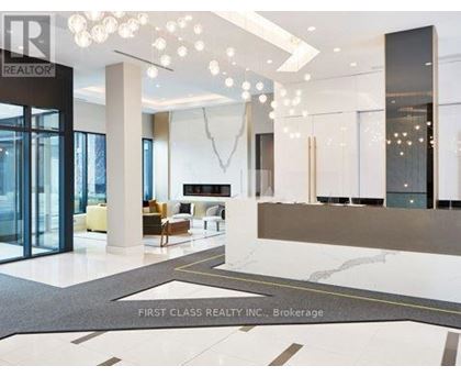 A foyer with a marble floor and a glass door.