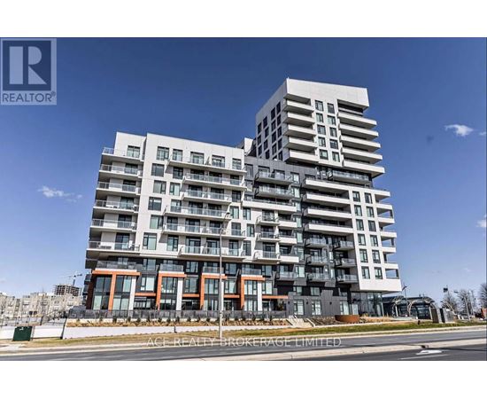 A modern multi-story building with balconies and a clear blue sky in the background.