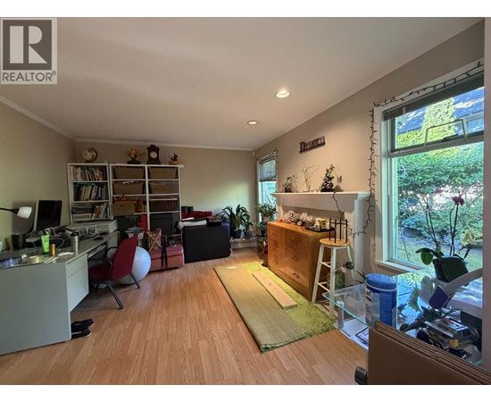 A living room with a couch, chair, and a bookshelf.