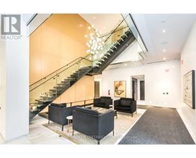 A living room with a staircase and a couch.