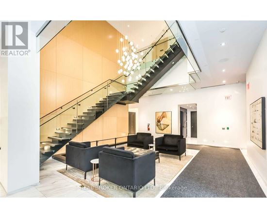 A living room with a staircase and a couch.