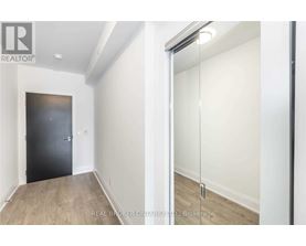 A room with a black door and a sliding glass door.