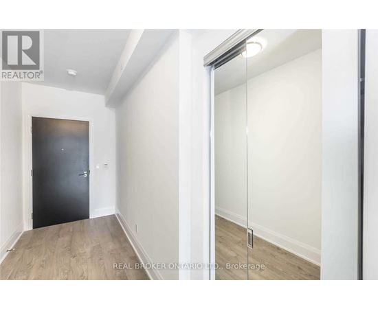 A room with a black door and a sliding glass door.