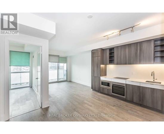 A modern kitchen with wooden cabinets and a large island.
