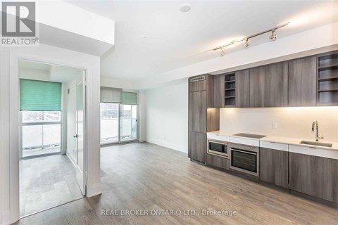 A modern kitchen with wooden cabinets and a large island.