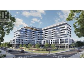 A modern multi-story building with a parking lot in front.