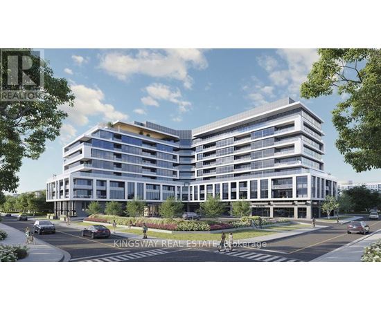A modern multi-story building with a parking lot in front.