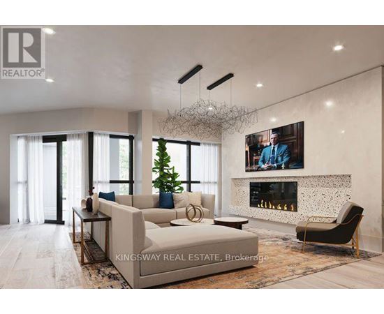 A modern living room with a large couch, a fireplace, and a painting on the wall.