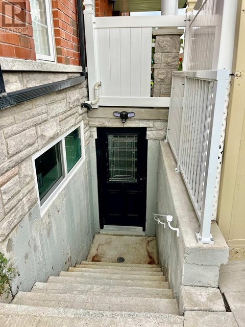 A small staircase leads to a door in a narrow alley.