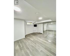 A room with a grey floor and white walls.