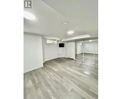 A room with a grey floor and white walls.