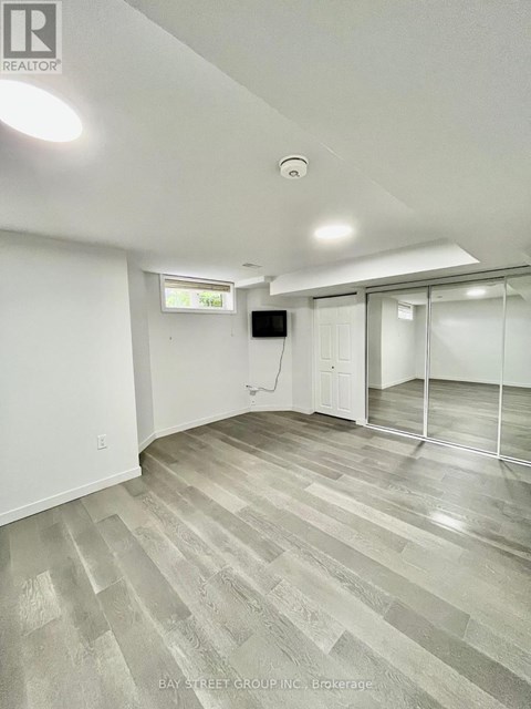 A room with a grey floor and white walls.