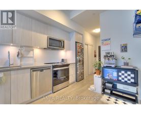 A modern kitchen with wooden cabinets and stainless steel appliances.