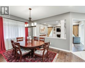 A dining room with a round table and chairs.