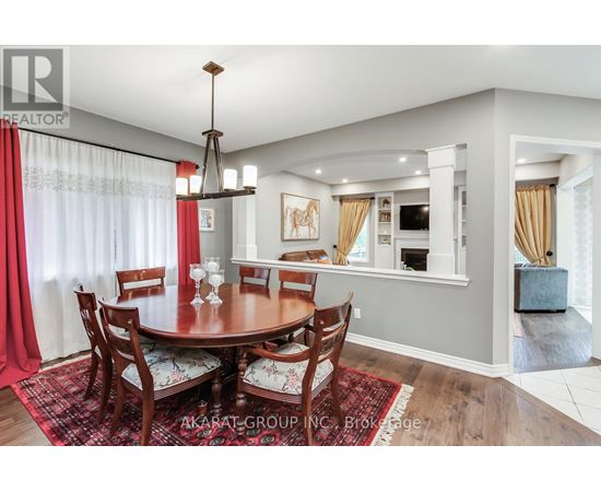 A dining room with a round table and chairs.