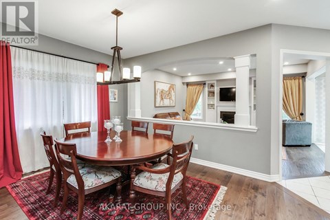 A dining room with a round table and chairs.