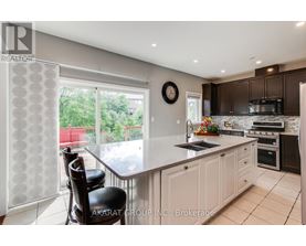 A kitchen with a table and chairs in front of a window.