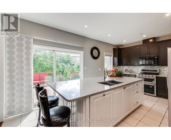 A kitchen with a table and chairs in front of a window.