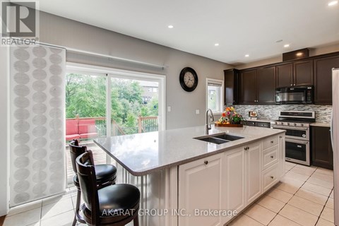 A kitchen with a table and chairs in front of a window.