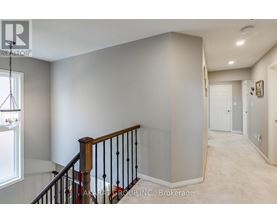 A spacious hallway with a staircase leading to the second floor.
