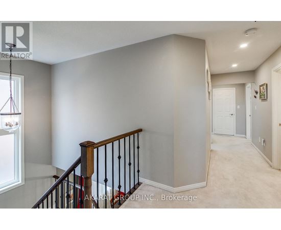 A spacious hallway with a staircase leading to the second floor.