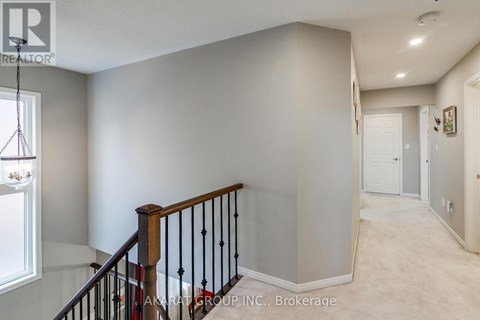 A spacious hallway with a staircase leading to the second floor.