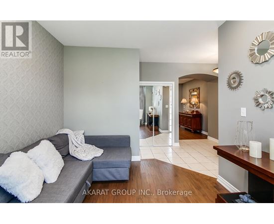 A living room with a grey couch and a wooden table.