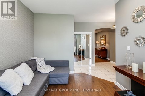 A living room with a grey couch and a wooden table.