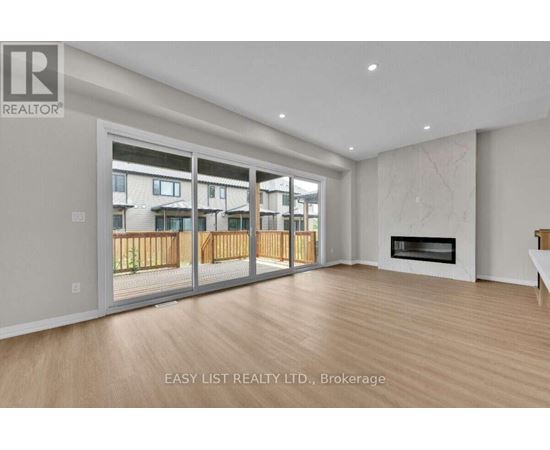 A spacious living room with a fireplace and sliding glass doors.