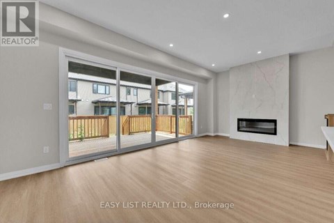 A spacious living room with a fireplace and sliding glass doors.