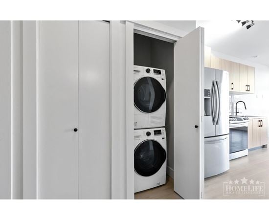 A white laundry room with a washer and dryer in it.