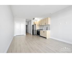 A kitchen with white cabinets and a wooden countertop.