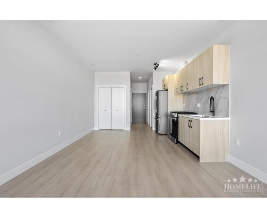 A kitchen with wooden floors and white walls.