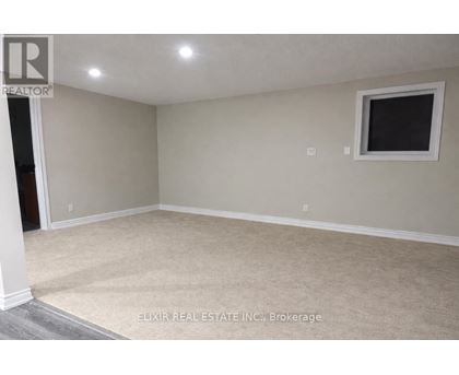 A room with a window and carpeted floor.