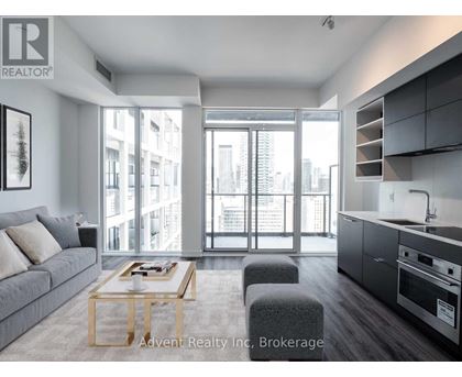 A modern living room with a grey sofa and a wooden coffee table.