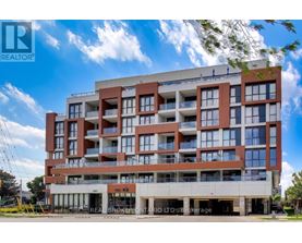 A large, modern apartment building with a clear blue sky above it.