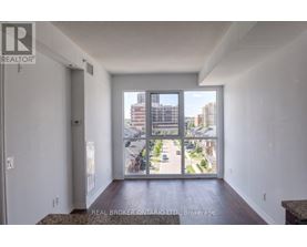 A real estate brokerage office with a view of a residential area outside.