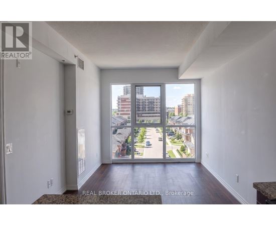 A real estate brokerage office with a view of a residential area outside.