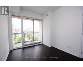 A room with a view of the city through large windows.