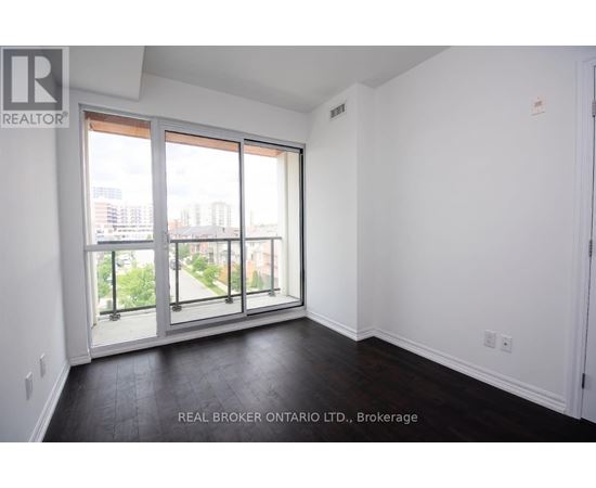 A room with a view of the city through large windows.